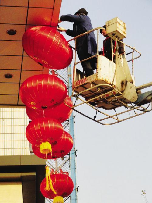 Hanging red lanterns to add festival atmosphere