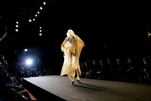 Models display beach couture duringh Rome Fashion Week