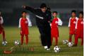 Maradona teaches children soccer skills in Dongguan