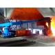 Robotic arm for feeding scrap material into IF induction furnace