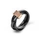 Tricyclic diamond ring wrapped around the fingers of black ceramic space