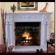 Electric marble fireplace mantel surrounds with stone figure carvings,China marble fireplace supplier