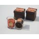 Orange & brown scented glass jar candle with printed label packed into gift box